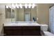 Bathroom featuring double sinks with a large mirror at 10618 W Crown King Rd, Tolleson, AZ 85353