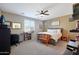 Bedroom with a ceiling fan, plantation shutters, a workspace and a cozy wooden bench at the foot of the bed at 10618 W Crown King Rd, Tolleson, AZ 85353