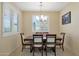 Formal dining room with a window, shutter blinds, and a chandelier, perfect for Gathering meals at 10618 W Crown King Rd, Tolleson, AZ 85353