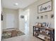 Inviting foyer with tile flooring, a console table with decor, and stylish artwork on the walls at 10618 W Crown King Rd, Tolleson, AZ 85353