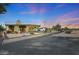 Expansive property featuring desert landscaping, a covered patio, and an upper-level deck for outdoor enjoyment at 10902 W Palmeras Dr, Sun City, AZ 85373