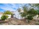 White house is pictured with desert landscaping, including a rock pathway, a gate, and drought-resistant plants at 1246 E Acoma Dr, Phoenix, AZ 85022