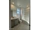 Bathroom featuring a tub and shower combination, grey cabinets and tile flooring at 15773 W Hackamore Dr, Surprise, AZ 85387