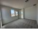 Bedroom featuring a window, carpet, and a closet with sliding doors at 15773 W Hackamore Dr, Surprise, AZ 85387