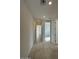 Hallway with tile flooring, recessed lighting, and white walls leading to a bright, airy living space at 15773 W Hackamore Dr, Surprise, AZ 85387