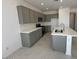 Kitchen boasts stainless steel appliances, white countertops, island with sink, and gray cabinets at 15773 W Hackamore Dr, Surprise, AZ 85387