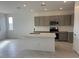 Kitchen boasts stainless steel appliances, white countertops, island with sink, and gray cabinets at 15773 W Hackamore Dr, Surprise, AZ 85387