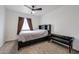 Comfortable bedroom with carpet, ceiling fan, window and a dark headboard with mounted shelving at 1614 E Javelina Cir, Mesa, AZ 85204