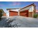 Spacious three car garage featuring carriage style doors at 16146 W Holly St, Goodyear, AZ 85395