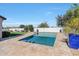 A stunning swimming pool with artificial turf and neutral pavers at 16146 W Holly St, Goodyear, AZ 85395