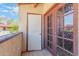 Private balcony with stucco walls and decorative glass doors at 16402 N 31St St # 228, Phoenix, AZ 85032
