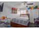 Cozy bedroom with ceiling fan, dartboard, and large window at 16402 N 31St St # 228, Phoenix, AZ 85032