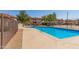 Community pool with fence and surrounding landscaping at 16402 N 31St St # 228, Phoenix, AZ 85032