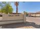 Community signage for Villa Capri with mature palm trees and covered parking at 16402 N 31St St # 228, Phoenix, AZ 85032