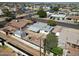 An aerial view of a home in a lively neighborhood, featuring a gravel backyard with a garden and covered patio at 1757 W Argon St, Mesa, AZ 85201