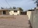 Spacious backyard featuring gravel, partial patio cover, and a well-maintained exterior at 1757 W Argon St, Mesa, AZ 85201
