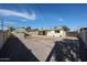 Low-maintenance backyard with storage shed, covered patio, and mature trees, ideal for outdoor living at 1757 W Argon St, Mesa, AZ 85201