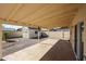 Spacious covered patio and low-maintenance backyard, featuring a storage shed and mature trees at 1757 W Argon St, Mesa, AZ 85201