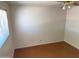 Simple bedroom with a ceiling fan, window with blinds and neutral walls and floors at 1757 W Argon St, Mesa, AZ 85201