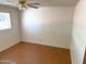 Modest bedroom featuring a ceiling fan, window with blinds, neutral walls, and floor at 1757 W Argon St, Mesa, AZ 85201