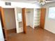 Bedroom features a closet with shelving, a mirror, and a ceiling fan with a light at 1757 W Argon St, Mesa, AZ 85201