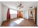 Bedroom featuring ceiling fan, large window and closet storage at 1757 W Argon St, Mesa, AZ 85201