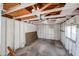 View of empty garage interior with exposed rafters and window at 1757 W Argon St, Mesa, AZ 85201