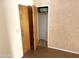 Hallway shot of a closet with wood door and storage, with potential for coats, linens, and other items at 1757 W Argon St, Mesa, AZ 85201