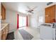 Eat-in kitchen with ceiling fan, exterior access door, sliding glass doors, and ample natural light at 1757 W Argon St, Mesa, AZ 85201