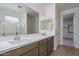 Bathroom featuring double sinks, modern cabinetry, and a large mirror at 17793 W Southgate Ave, Goodyear, AZ 85338