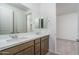 Bathroom featuring double sinks, modern cabinetry, and a large mirror at 17793 W Southgate Ave, Goodyear, AZ 85338