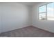 Bright bedroom features neutral carpet, white walls, and a large window at 17793 W Southgate Ave, Goodyear, AZ 85338