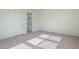 Bright bedroom features neutral carpet, white walls, and walk-in closet and bathroom entry at 17793 W Southgate Ave, Goodyear, AZ 85338