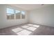 Sunlit bedroom with plush carpet, three large windows, and neutral paint, creating a comfortable and inviting atmosphere at 17793 W Southgate Ave, Goodyear, AZ 85338