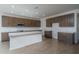 Expansive kitchen showcases a center island with white countertop and an abundance of cabinet space at 17793 W Southgate Ave, Goodyear, AZ 85338
