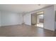 Bright living area with light tile flooring and sliding glass door to outside space at 17793 W Southgate Ave, Goodyear, AZ 85338