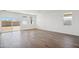 Bright living room featuring wood-look tile floors, a large sliding glass door, and abundant natural light at 18891 E Bruno Dr, Gold Canyon, AZ 85118