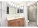 Bright bathroom featuring a vanity with a mirror and a glass-enclosed shower at 1920 W Lindner Ave # 249, Mesa, AZ 85202