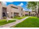 Condo building featuring well-maintained landscaping and a charming walkway at 1920 W Lindner Ave # 249, Mesa, AZ 85202