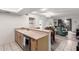 Open-concept kitchen with stainless steel appliances and breakfast bar looking into living room at 1920 W Lindner Ave # 249, Mesa, AZ 85202