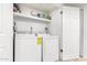 Bright laundry room featuring a washer, dryer, and shelving at 1920 W Lindner Ave # 249, Mesa, AZ 85202