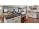 Close-up of kitchen island with stone countertops, bar seating, and stainless steel appliances at 19805 N 99Th Dr, Sun City, AZ 85373