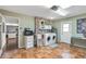 Well-lit laundry room with brick accent wall and modern washer and dryer at 19805 N 99Th Dr, Sun City, AZ 85373