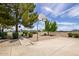 Outdoor community basketball court area with concrete, gravel, trees, and blue skies at 20329 E Bronco Dr, Queen Creek, AZ 85142