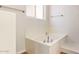 A corner soaking tub, perfect for relaxing, is bathed in light from a strategically placed window at 20329 E Bronco Dr, Queen Creek, AZ 85142