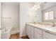 Well-lit bathroom with a tub and shower combination plus a dual sink vanity with marble countertops at 20329 E Bronco Dr, Queen Creek, AZ 85142