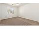 Bright carpeted bedroom with a ceiling fan and a large window offering outside views at 20329 E Bronco Dr, Queen Creek, AZ 85142