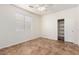 Neutral bedroom features tile flooring, ceiling fan, a window and closet at 20329 E Bronco Dr, Queen Creek, AZ 85142