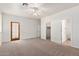 Bright bedroom with a ceiling fan and three doorways including the main bedroom and closet at 20329 E Bronco Dr, Queen Creek, AZ 85142
