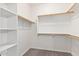 Walk-in closet with built-in shelving and wooden rods providing ample storage at 20329 E Bronco Dr, Queen Creek, AZ 85142